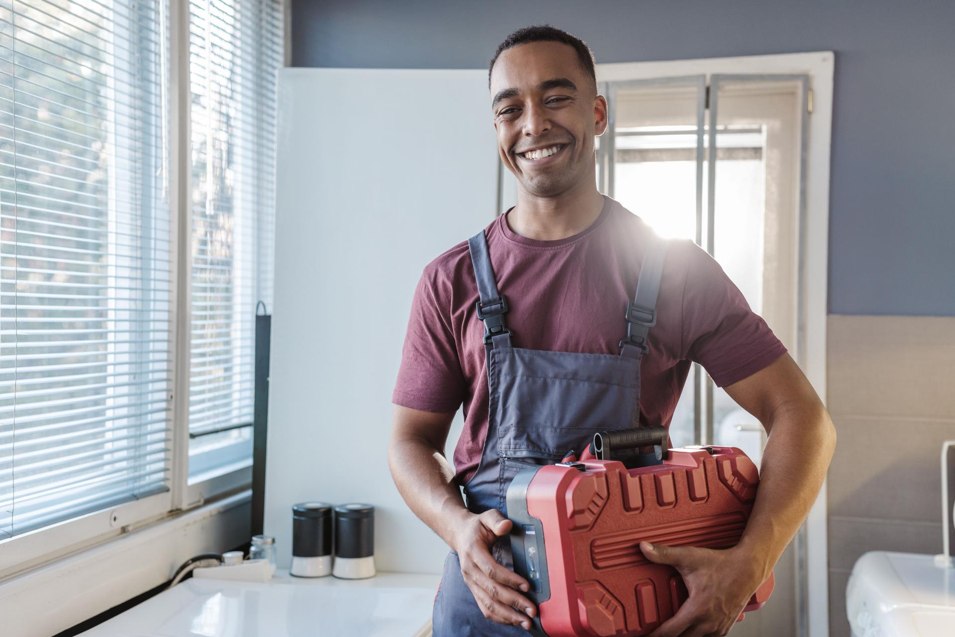 Portrait of a young African American handyman in customer home